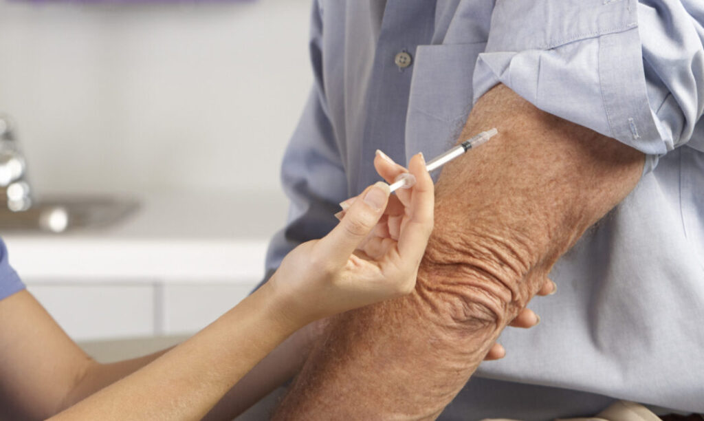 Doctor Giving Male Patient Injection