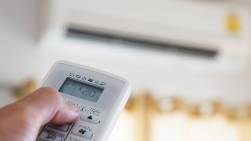 Close-up,Hand,Using,Remote,Control,Of,Air,Condition,,Selective,Focus